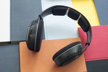 Group of colorful books and headphones related to audiobooks