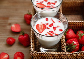 Two Glasses of Yogurt,Red Fresh Strawberries in the Rattan Box on the Wooden Table.Breakfast Organic Tasty Food.Cooking Vitamins Ingredients.Summer Fruits.