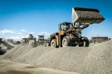 the tractor in the quarry for the extraction of gravel shovel gravel bucket