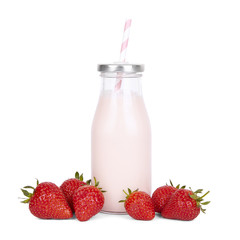 Drinks and milk shakes - a strawberry milkshake in a vintage glass bottle with straw and fruit isolated on a white background