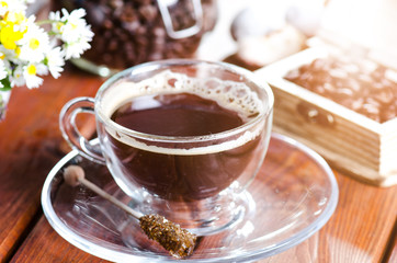 cup of coffee on a wooden backgound. Flowers and grass. Natural background. Agricultural.Garden  