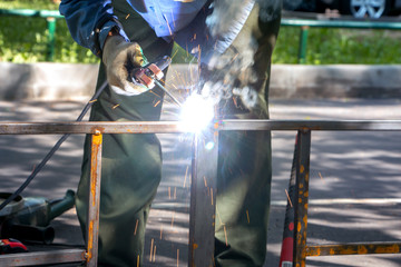 welder makes metal fence
