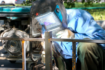 welder makes metal fence