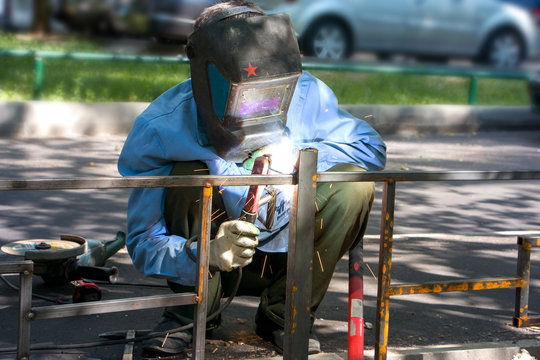 welder makes metal fence