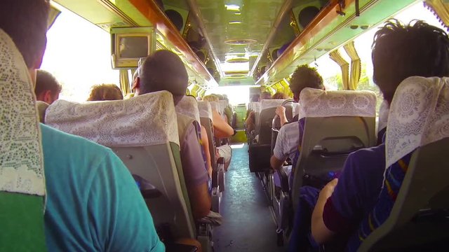 Video FullHD - Fully loaded passenger bus bounces and lurches over a poorly maintained roadway, providing cheap transportation in Southeast Asia.