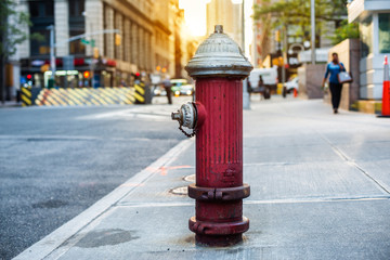 Old red fire hydrant in New York City street. Fire hidrant for emergency fire access