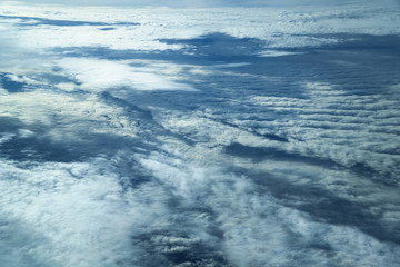 Naklejka na ściany i meble Clouds view from a plane window early morning