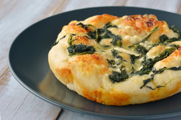 Turkish flat bread with cheese and spinach topping