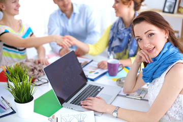 Portrait of attractive female designer in office