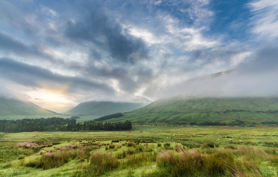 Morning Sunlight Through Clouds and Mist over Scottish Highlands