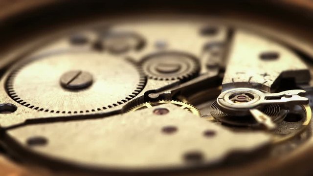 Video 3840x2160 - Open back of a watch, displaying a wind-up, spring-powered, clockwork mechanism. Moving parts are spinning and functioning as designed.