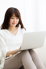 attractive asian woman using laptop