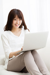 attractive asian woman using laptop