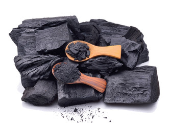 Natural wood charcoal and charcoal powder on wooden spoon isolat - obrazy, fototapety, plakaty