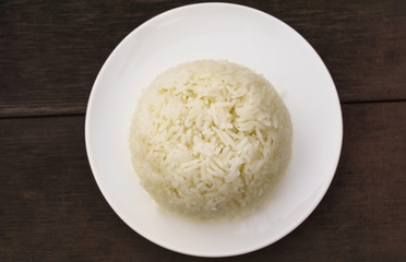 Cooked rice with plate isolated on Wood Table 