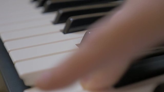 Improvised one finger glissando on electric keyboard slow motion 1920X1080 HD footage - Slow-mo glissando roll over piano keys 1080p FullHD video 