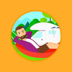 Man lying in hammock in front of motor home.