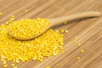 Peeled split mung beans, Close-up peeled split mung beans on a wood spoon