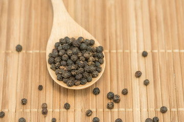 Fototapeta na wymiar Black pepper, Close-up black pepper on a wood spoon