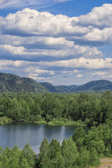 Naklejka na ściany i meble Landscape with lake, mountains and forest