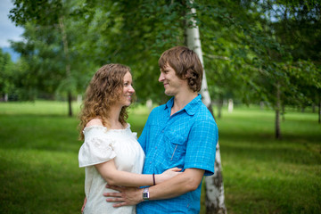 Fototapeta premium Portrait of a happy loving couple outdoor in the green park