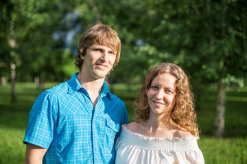 Portrait of a happy loving couple outdoor in the green park