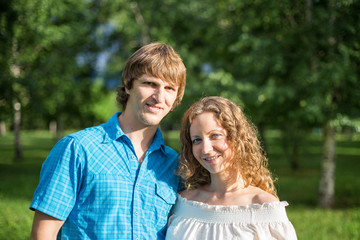 Fototapeta premium Portrait of a happy loving couple outdoor in the green park