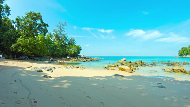 4k video - Panning across a beautiful, exotic, tropical beach at low tide, under a bright blue sumer sky in southern Thailand, with sound.