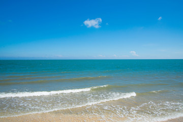 Turquoise sea wave on the empty sea beach blue sky sand sun daylight.
