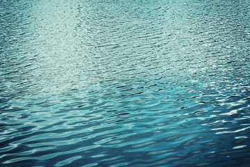 Texture of the water with waves or ripples for your background and design. Vintage turquoise color.