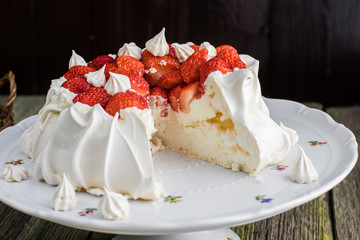 Sliced Pavlova Cake with Strawberries on White Plate