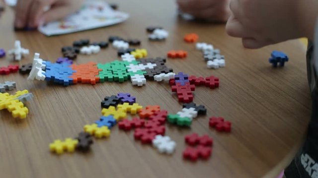 Child play with colorful pazzle shapes