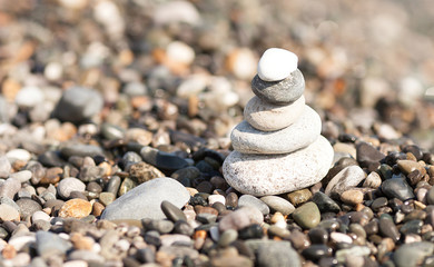 Fototapeta na wymiar pile of white stones on the beach. Sea blurred background