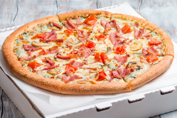 Delicious pizza with mushrooms and ham