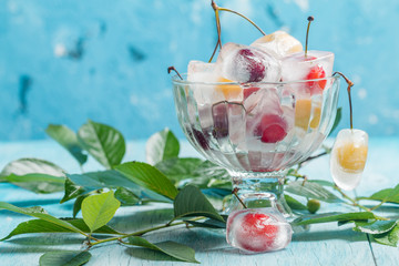 Cherry in ice cube in glass bowl 