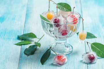 Cherry in ice cube in glass bowl 