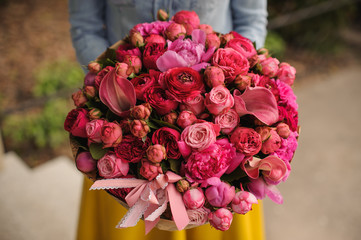 girl holding a bouquet of pink flowers