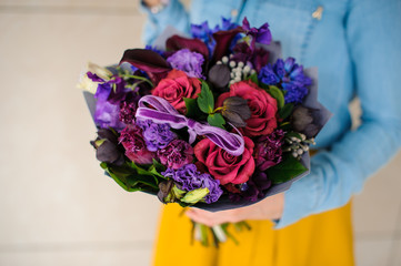 girl holding purple and pink flower bouquet