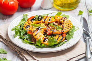 Delicious grilled pumpkin and arugula  salad 