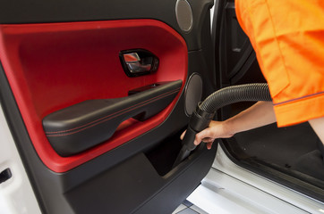 Cleaning of interior of the car with vacuum cleaner