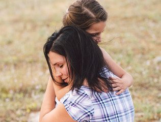Fototapeta premium Mother comforting her sad daughter