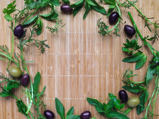 Fototapety  Herbs and spices in a round frame on bamboo background. Top view