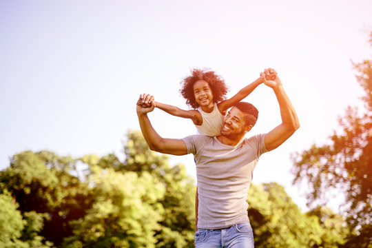 Child Flying On Father Shoulders