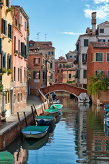Fototapeta na wymiar Street scene with canal in Venice, Italy
