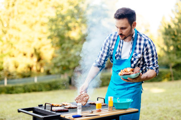 Handsome man preparing barbecue