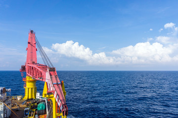 Offshore crane on construction work barge at oilfield