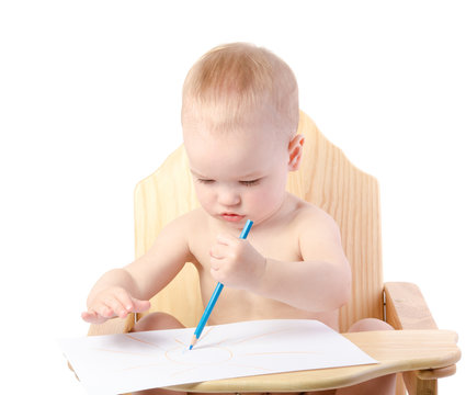 A boy draws with a pencil , isolated on white background