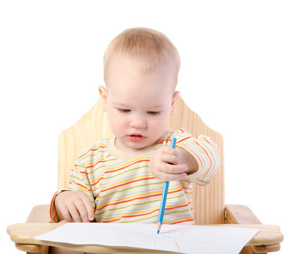 A boy draws with a pencil , isolated on white background