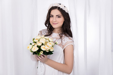 beautiful bride in white dress with flowers