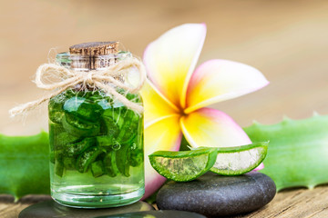 Aloe vera and frangipani flower on wooden